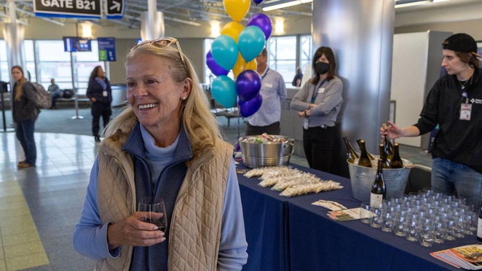 Gail Severn, of Ketchum, holds a sample of Kendall-Jackson Pinot Noir as she arrives at the Boise Airport for Avelo Airlines’ inaugural direct flight from Boise to Sonoma County on Thursday.