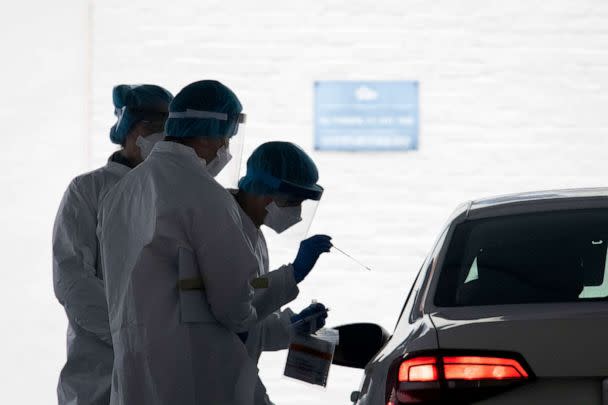 PHOTO: A healthcare worker takes a test swab of an individual at a drive-thru testing facility at George Washington University in Washington, D.C. on April 23, 2020 amid the Coronavirus pandemic. (Graeme Sloan/Sipa USA via AP)