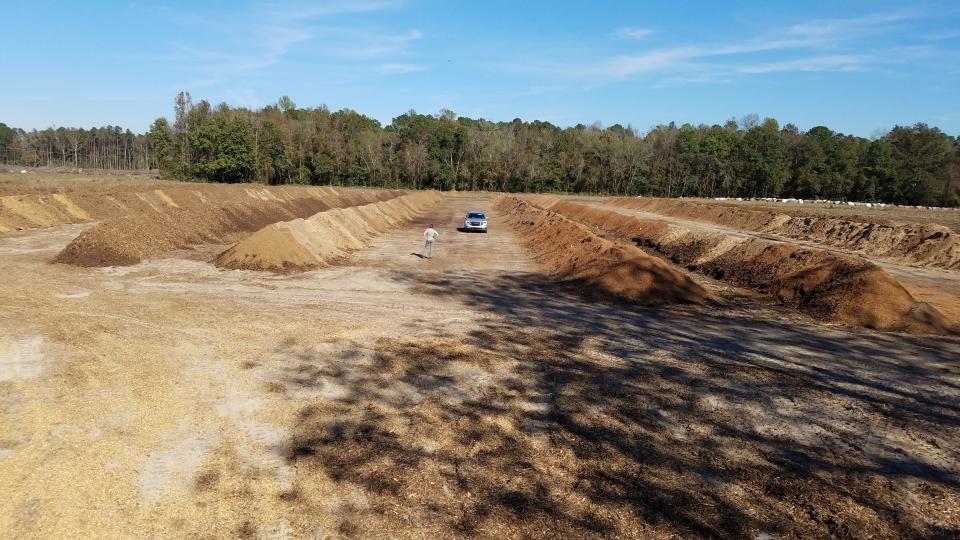 Rows of composted chicken carcasses line a farm in North Carolina following Hurricane Florence in 2018. After historically disposing of millions of dead livestock and poultry carcasses by incineration or landfill following storms,  the state's Department of Agriculture and Community Services now encourages farmers to compost, which is environmentally beneficial.