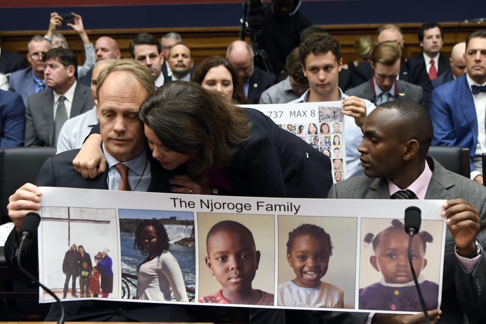 Rep. Angela Craig, D-Minn., center, hugs Michael Stumo, left, as Paul Njoroge, right, looks on before the start of a House Transportation subcommittee hearing on Capitol Hill in Washington, Wednesday, July 17, 2019, on aviation safety. Njoroge lost his wife and three young children on Ethiopian Airlines Flight 302 and Stumo lost his daughter on the same flight. The plane was a Boeing 737 MAX. (AP Photo/Susan Walsh)