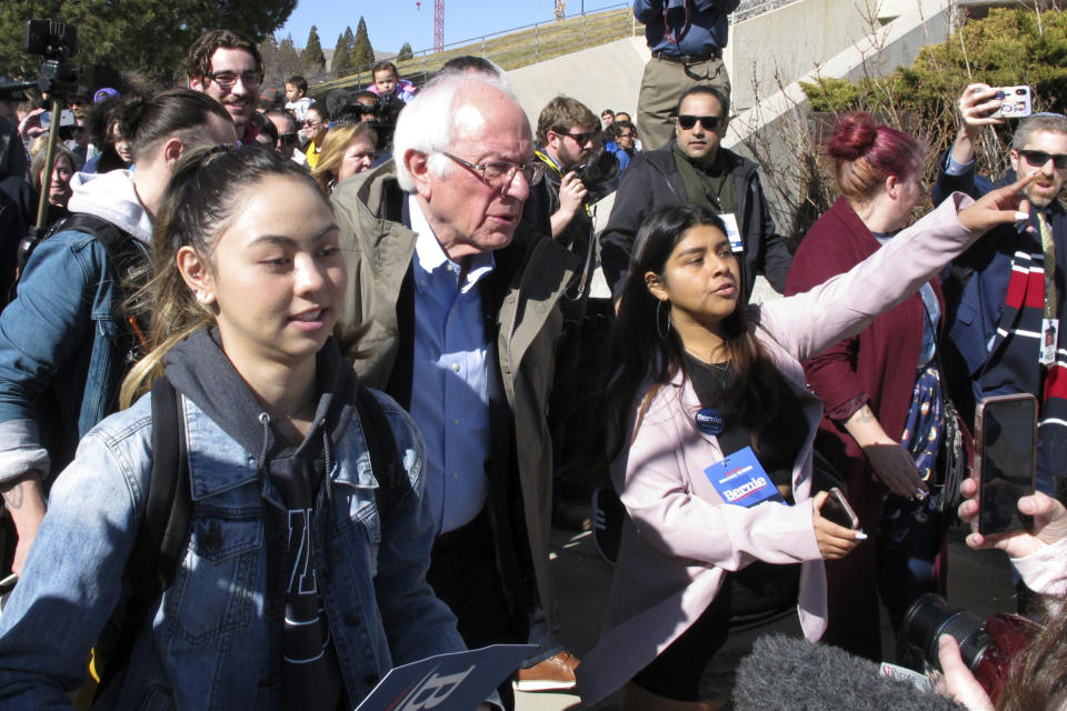 Democratic presidential candidate U.S. Sen. Bernie Sanders, I-Vt., capped a speech to hundreds of people on the campus of the University on Nevada, Reno, Tuesday, Feb. 18, 2020, by leading several dozen on a two-block march to the student union to cast their ballot on the final day of early voting ahead of Saturday's presidential caucuses. Sanders accused billionaire rival Mike Bloomberg for trying to buy the Democratic nomination and said his own campaign is the campaign for working class people. (AP Photo/Scott Sonner)