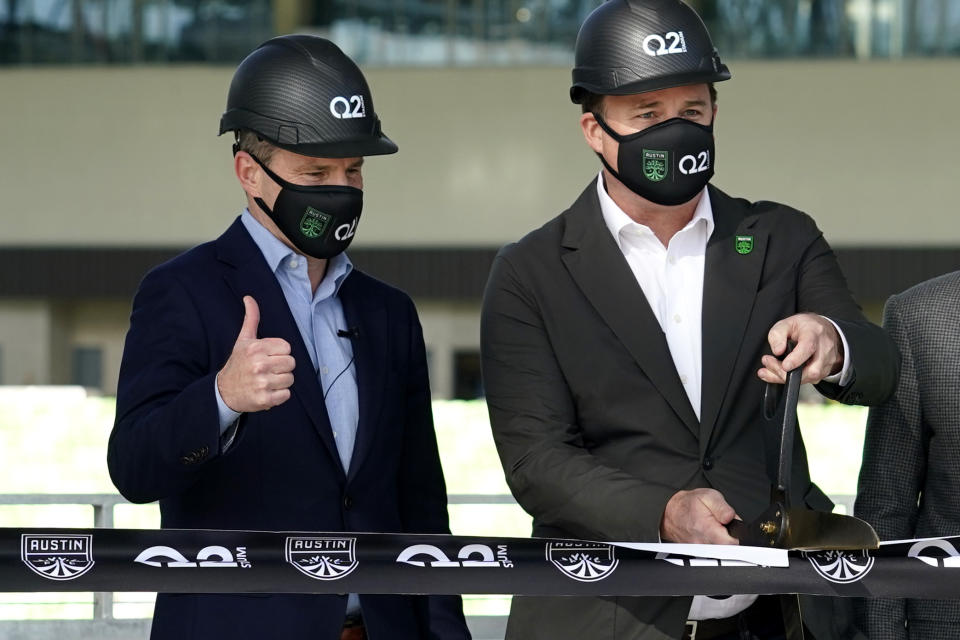 FILE - In this Jan. 25, 2021, file photo, Q2 Holdings Inc. CEO Matt Flake, left, and Austin FC majority owner Anthony Precourt, right, take part in a ribbon-cutting ceremony as the team's new stadium is named Q2 Stadium in Austin, Texas. Austin FC is MLS's newest expansion team and had to build the $260-million facility and a team roster amid the global pandemic. Austin FC opens the 2021 season Saturday, April 17, 2021, at Los Angeles FC. (AP Photo/Eric Gay, File)