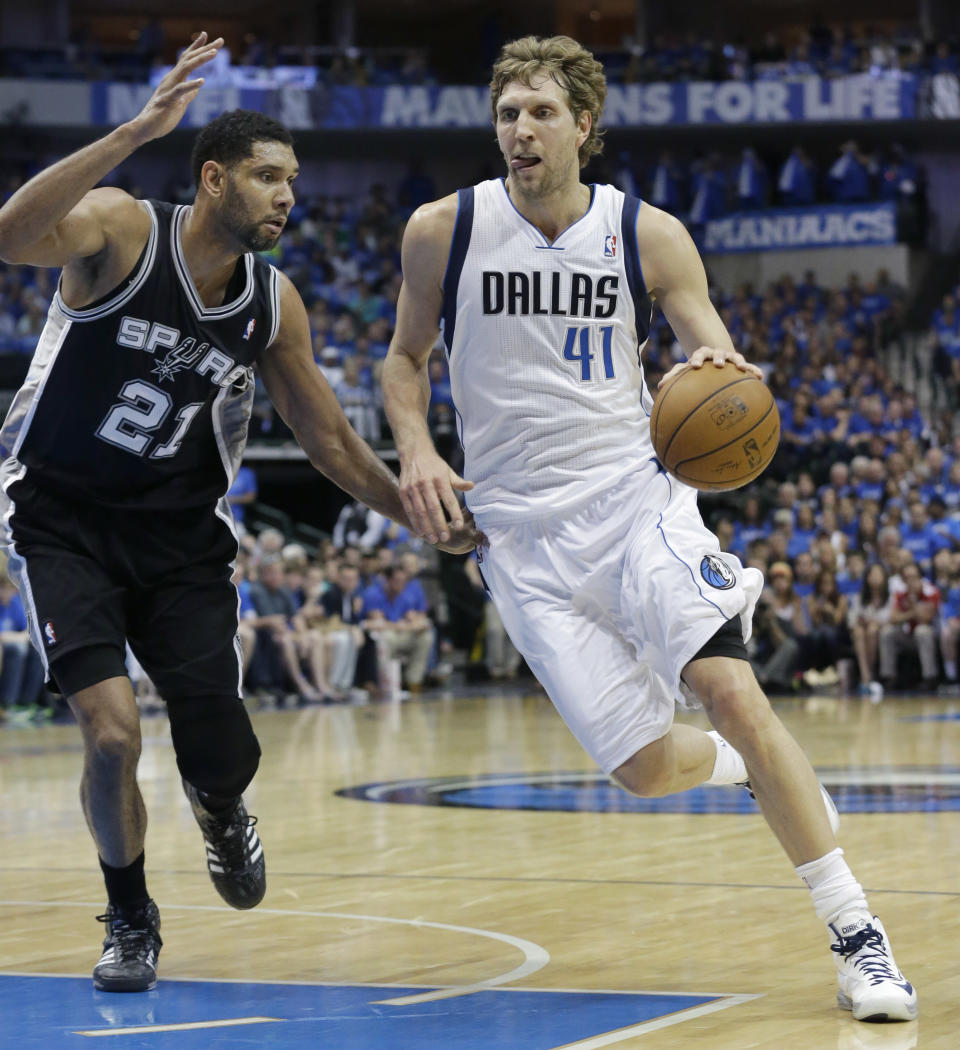 Dallas Mavericks forward Dirk Nowitzki (41), of Germany, drives against San Antonio Spurs forward Tim Duncan (21) during the first half of Game 3 of an NBA basketball first-round playoff series in Dallas, Saturday, April 26, 2014. (AP Photo/LM Otero)
