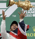 Mercedes driver Lewis Hamilton of Britain celebrates on the podium after winning the British Formula One Grand Prix at the Silverstone racetrack, Silverstone, England, Sunday, July 14, 2019. (AP Photo/Luca Bruno)