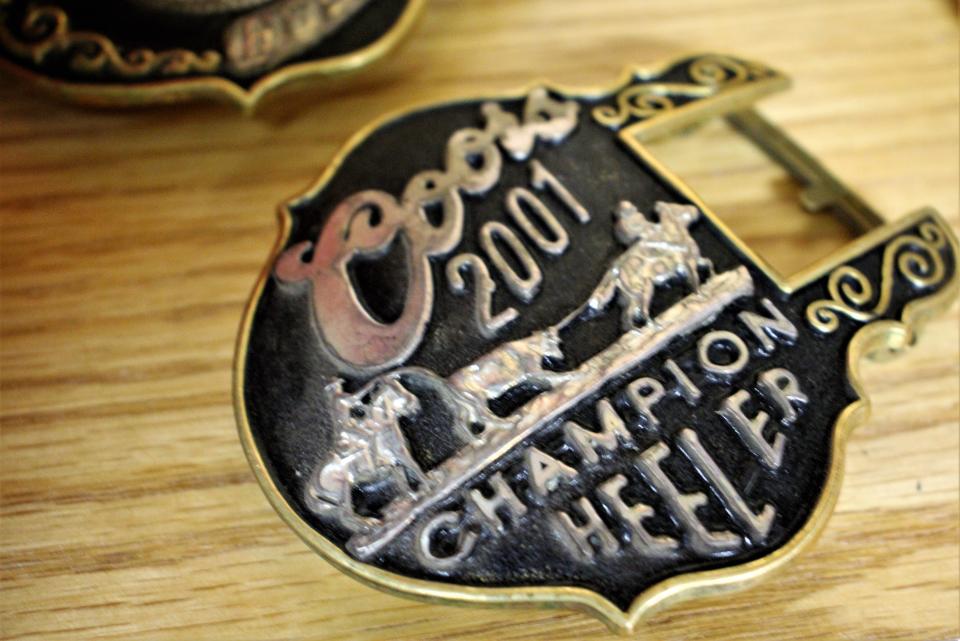 A belt buckle won by "Cowboy John" Rogers, a Black West Texan who starred in the rodeo arena.