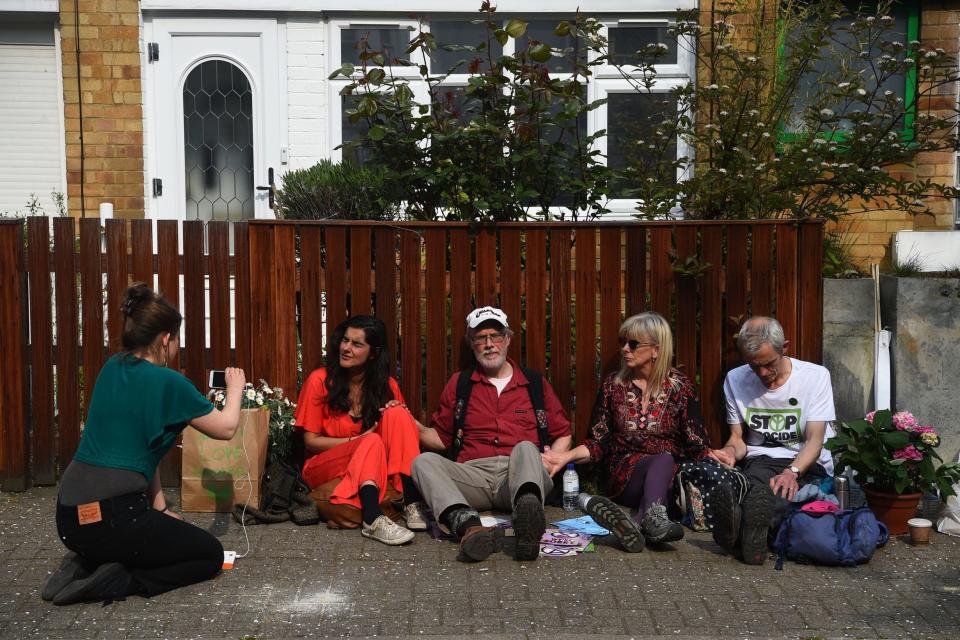 Two men and two women from the Extinction Rebellion group have glued themselves to a fence outside Jeremy Corbyn's house (PA)