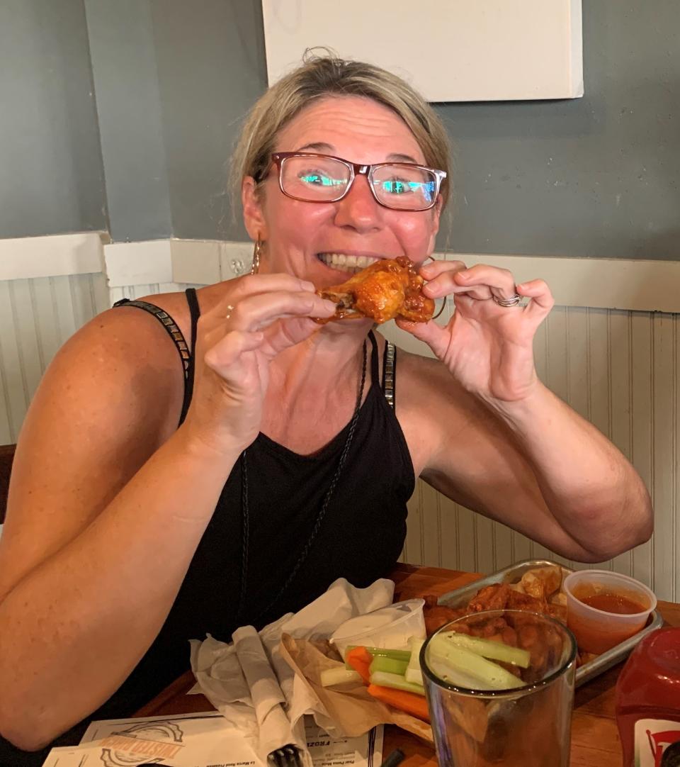 Emma Kirkpatrick of Rockledge dives into a plate of wings at Twisted Birch Sports Bar & Grill in Rockledge.