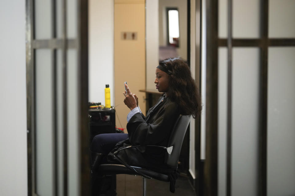 A customer waits for a hair treatment, in a hairdressing salon, in Paris, Wednesday, March 27, 2024. French lawmakers are debating a bill Thursday that would ban discrimination over the texture, length, color or style of someone's hair. (AP Photo/Thibault Camus)