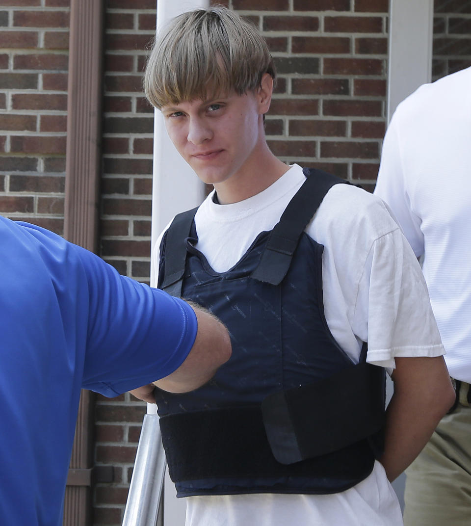 Charleston, S.C., shooting suspect Dylann Storm Roof is escorted from the Sheby Police Department  in Shelby, N.C., Thursday, June 18, 2015. (AP Photo/Chuck Burton)