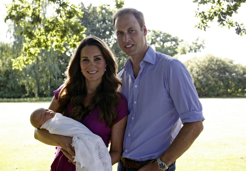 This image taken by Michael Middleton, father of Kate, the Duchess of Cambridge, in early August 2013 and provided by Kensington Palace, shows the Duke and Duchess of Cambridge with their son, Prince George, in the garden of the Middleton family home in Bucklebury, England. (AP Photo/Michael Middleton/TRH The Duke and Duchess of Cambridge)