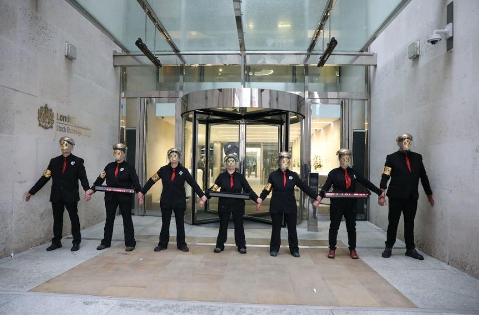 Extinction Rebellion protesters glued themselves to the entrances of the London Stock Exchange in the City of London this morning (PA)