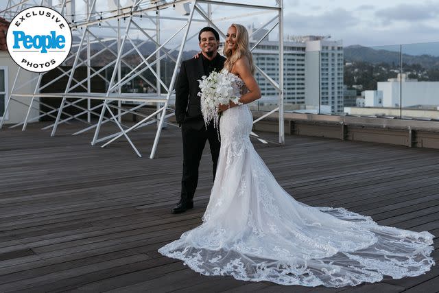 <p>DeAngelo Castro for SYMBOLL</p> Nita Strauss and Josh Villalta pose at their wedding