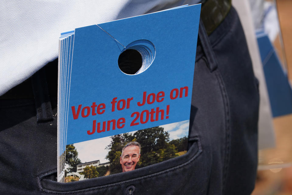 Virginia state Sen. Joe Morrissey keeps a batch of door hangers in his back pocket as he canvases a neighborhood, Monday, May 22, 2023, in Petersburg, Va. Morrissey is being challenged in a Democratic primary for a newly redrawn senatorial district by former Delegate Lashrecse Aird. (AP Photo/Steve Helber)