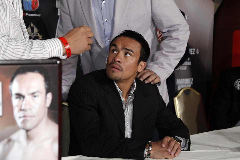 Manny Pacquiao, of the Philippines, Juan Manuel Marquez, of Mexico, promote their upcoming fourth boxing match, at a news conference in Beverly Hills, Calif., Monday, Sept. 17, 2012. The fight will take place Dec. 8 in Las Vegas. (AP Photo/Reed Saxon)