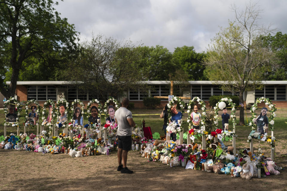 Brian Hackett, 39, visits a memorial at Robb Elementary School in Uvalde, Texas Monday, May 30, 2022, to pay his respects to the victims killed in last week's school shooting. (AP Photo/Jae C. Hong)