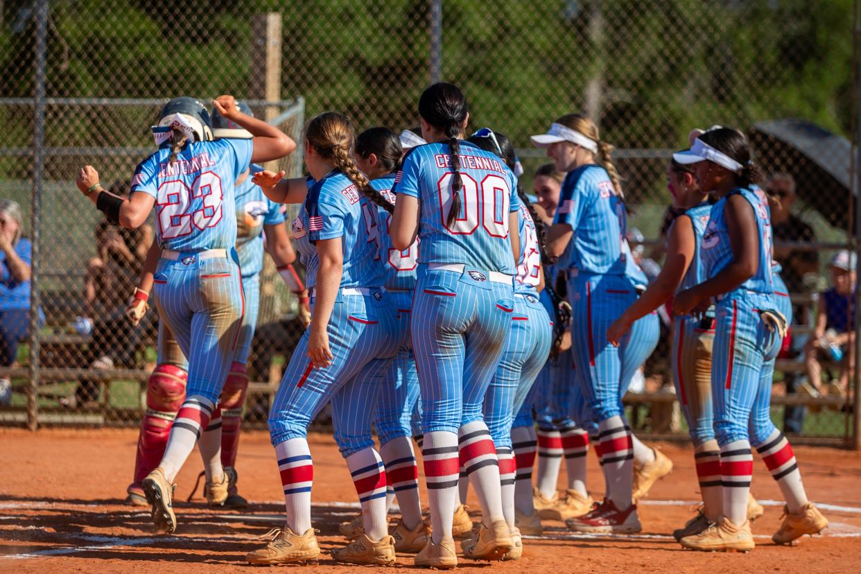 Centennial's Hailey Brereton (23) crosses home plate amidst cheering teammates after a solo homerun to end the game against Harmony in a high school softball Region 3-7A quarterfinal Thursday, May 9, 2024, at St. Lucie West Centennial High School in Port St. Lucie.