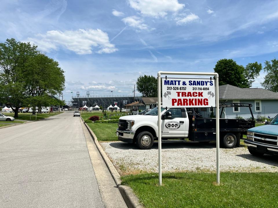 A sign advertises parking at Sandy Rosner's property on West 24th Street with the Indianapolis Motor Speedway in the distance on Monday, May 20, 2024.