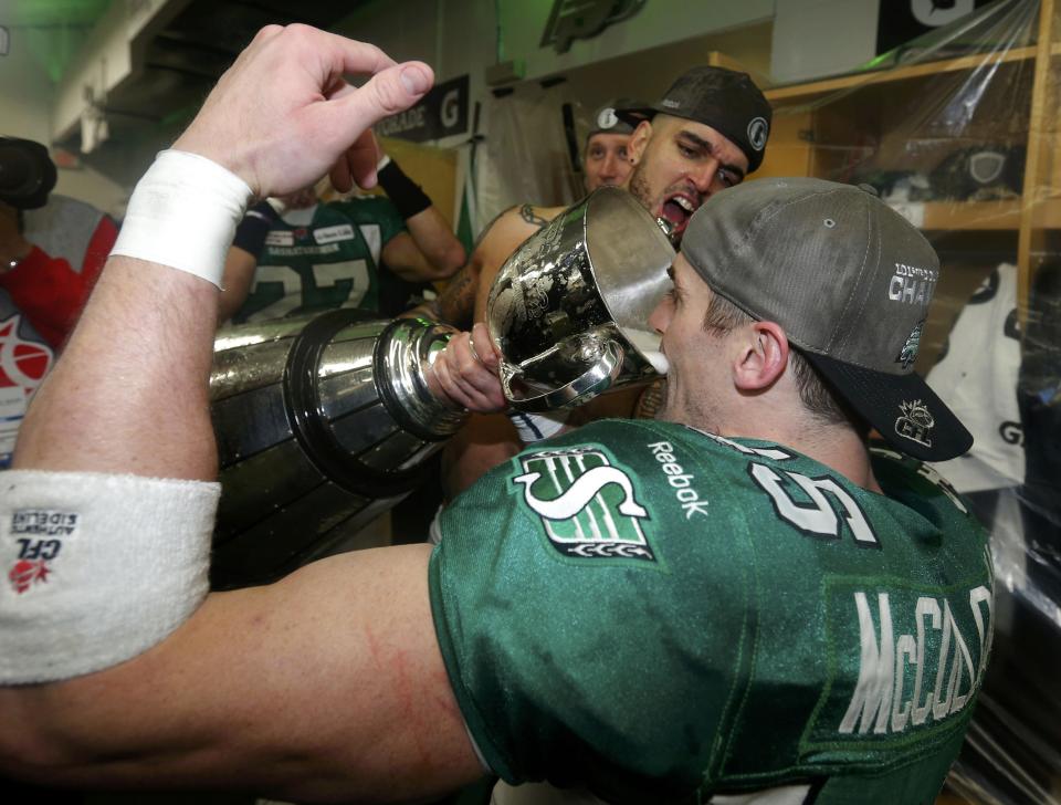 Saskatchewan Roughriders Mike McCullough drinks from the Grey Cup after his team defeated the Hamilton Tiger Cats to win the CFL's 101st Grey Cup championship football game in Regina, Saskatchewan November 24, 2013. REUTERS/Todd Korol (CANADA - Tags: SPORT FOOTBALL)