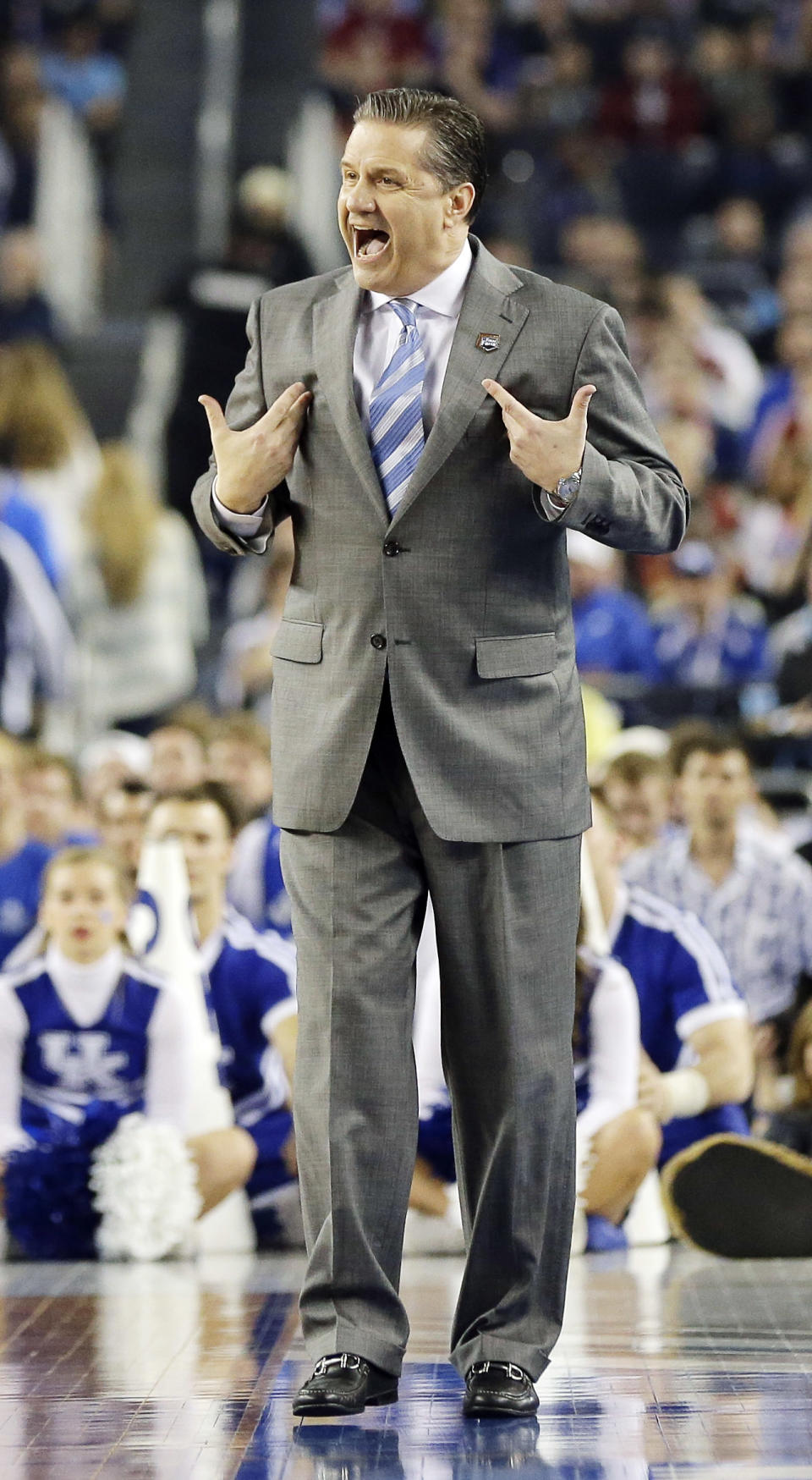 Kentucky head coach John Calipari works the sideline against Wisconsin during the first half of the NCAA Final Four tournament college basketball semifinal game Saturday, April 5, 2014, in Arlington, Texas. (AP Photo/Eric Gay)