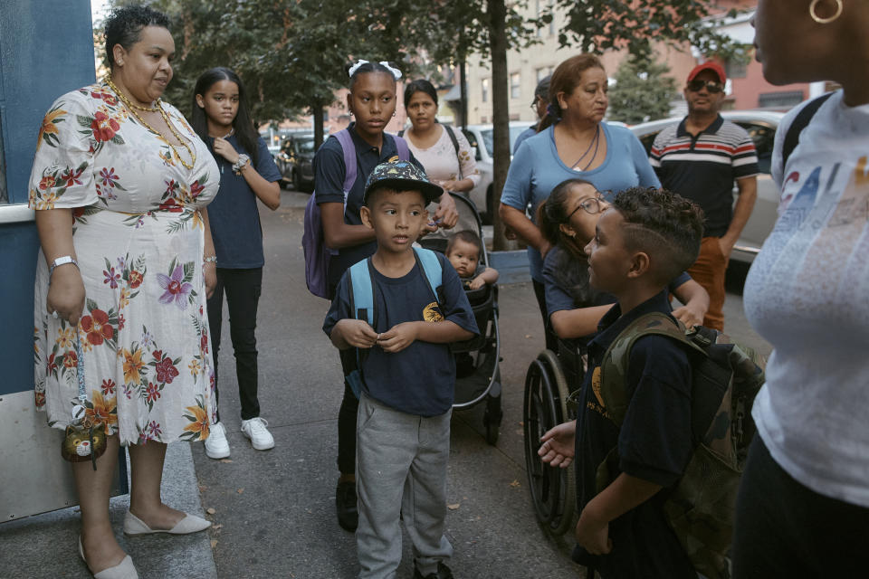 Damien Salinas, 5 years old, center front, arrives to school and looks for the right entrance on Thursday, Sept. 7, 2023, in New York. Damien attends his first day of school in New York City after his family emigrated from Ecuador in June. Damien and her family have been living in a room at the historic Roosevelt Hotel, converted into a city-run shelter for newly arrived migrant families hoping to find work, a new home and a better life for their children. (AP Photo/Andres Kudacki)