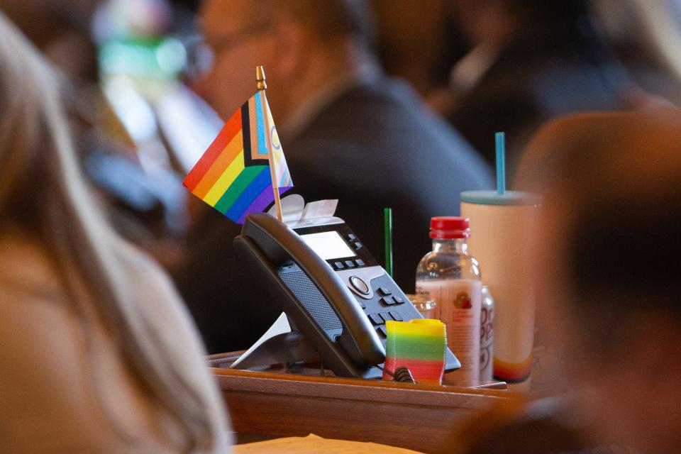 A pro-LGBTQ+ flag is seen on the desk of Rep. Heather Meyer, D-Overland Park, during session on Wednesday. Kansas school districts must separate students by their biological sex on overnight trips, the latest in a string of bills on transgender students.