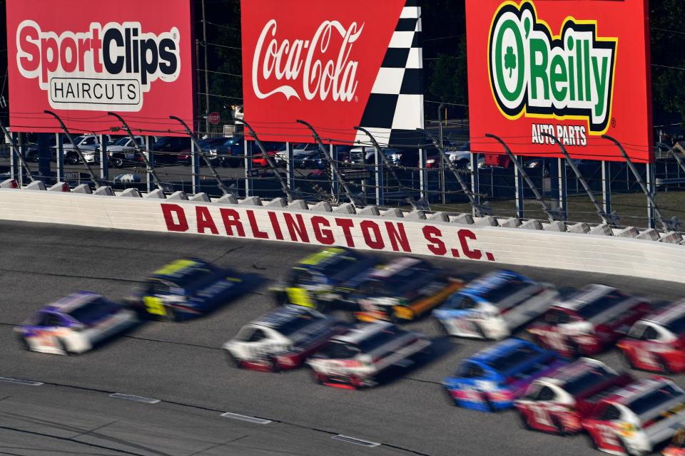 NASCAR Cup Series drivers race through Turn 1 at Darlington Raceway.