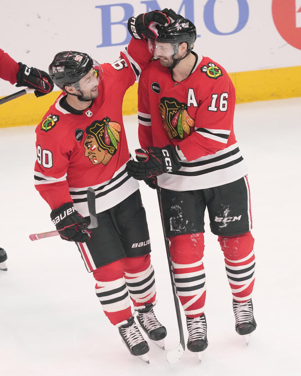Chicago Blackhawks' Tyler Johnson (90) celebrates with Jason Dickinson after Dickinson's go ahead goal in the third period of an NHL hockey game against the Ottawa Senators Saturday, Feb. 17, 2024, in Chicago. The Blackhawks won 3-2. (AP Photo/Charles Rex Arbogast)