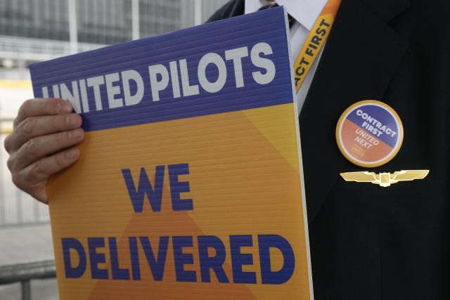 A member of the Air Line Pilots Association International walks an informational picket on behalf of United Airline pilots at O'Hare International Airport Friday, May 12, 2023, in Chicago. (AP Photo/Charles Rex Arbogast)