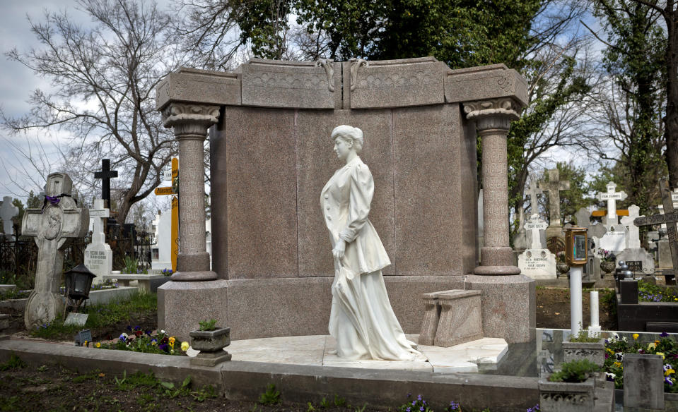 This April 10, 2013 photo shows a statue at a grave at the Bellu cemetery in Bucharest, Romania. It was founded by a shepherd, according to local legend, and was later nicknamed the Paris of the East. But Bucharest's idyllic roots and elegant reputation eventually gave way to a series of 20th century calamities: war, invasions, earthquakes and communism.(AP Photo/Vadim Ghirda)