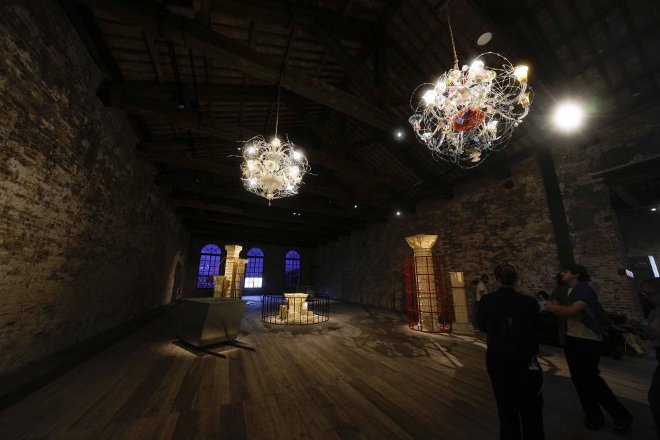 Visitors look the installation "Hollow and Broken," by artist Gulsun Karamustafa at the Turkish pavilion at the 60th Biennale of Arts exhibition in Venice, Italy, Tuesday, April 16, 2024. The Venice Biennale contemporary art exhibition opens Saturday for its six-month run through Nov. 26. Alongside the main exhibition, 88 national pavilions fan out from the traditional venue in Venice's Giardini, to the Arsenale and other locations scattered throughout the lagoon city. (AP Photo/Luca Bruno)