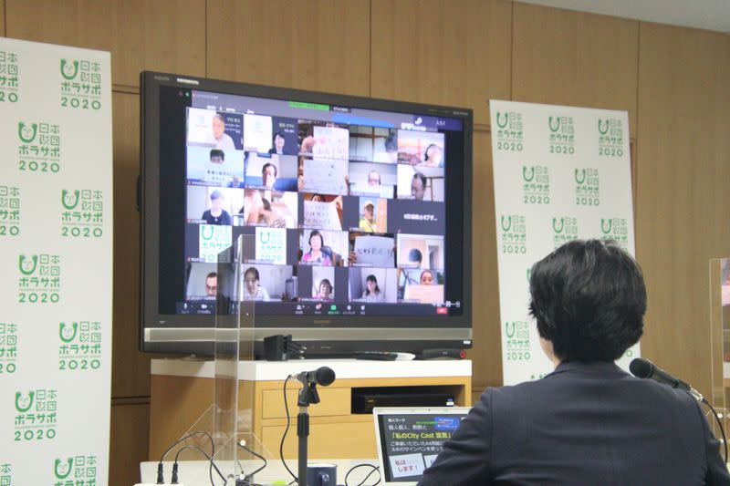 A screen displays an online gathering with volunteers for the 2020 Olympics in Tokyo