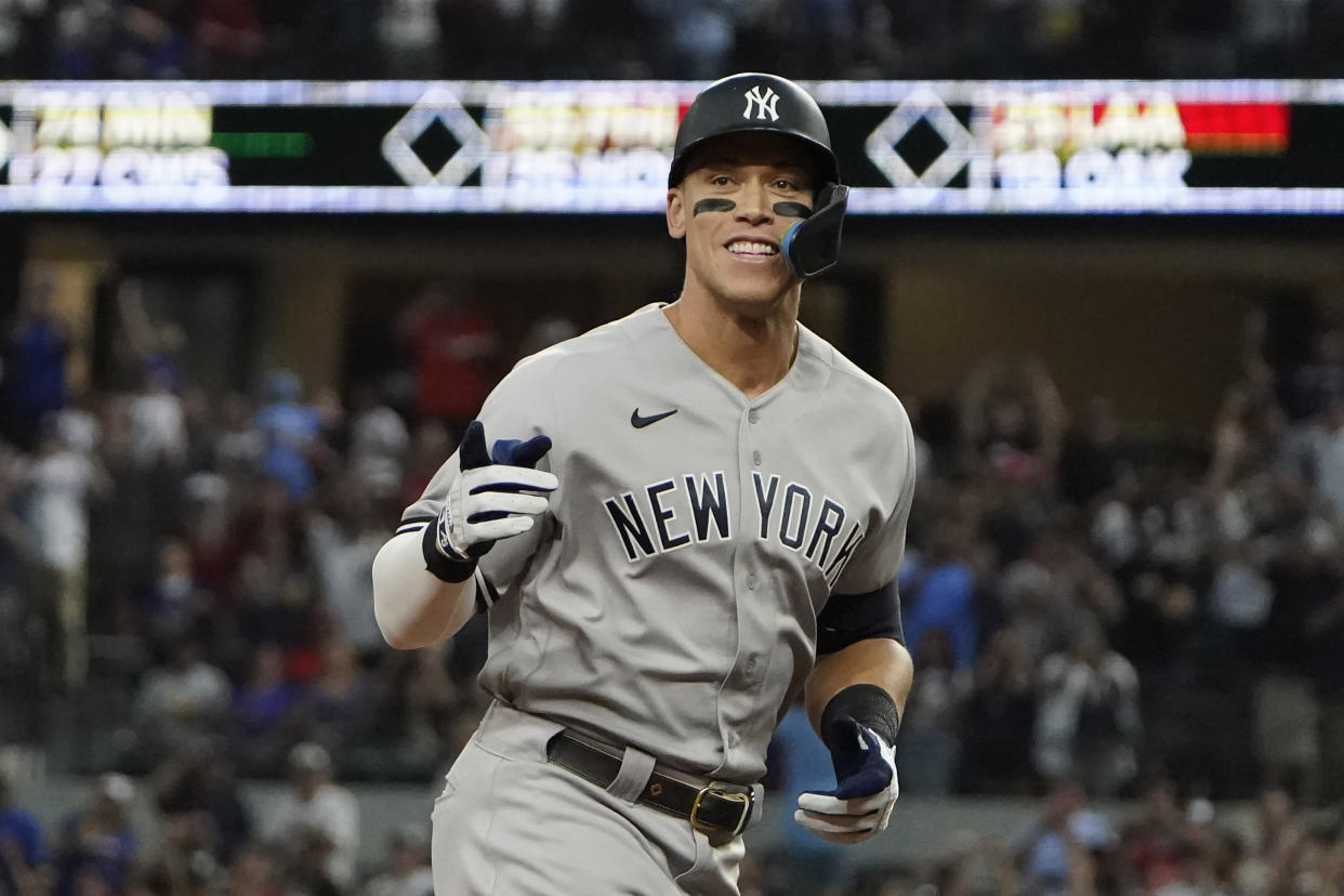 New York Yankees' Aaron Judge gestures as he rounds the bases after hitting his 62nd of the season against the Texas Rangers in Arlington, Texas, Tuesday, Oct. 4, 2022. (AP Photo/LM Otero)