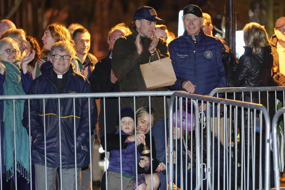 President Joe Biden stands with his son Hunter Biden and other family members during the annual Christmas Tree Lighting ceremony in Nantucket, Mass., Friday, Nov. 25, 2022. Ashley Biden talks with Melissa Cohen as she helps her son Beau Biden ring a bell that was given to him by the town crier. (AP Photo/Susan Walsh)