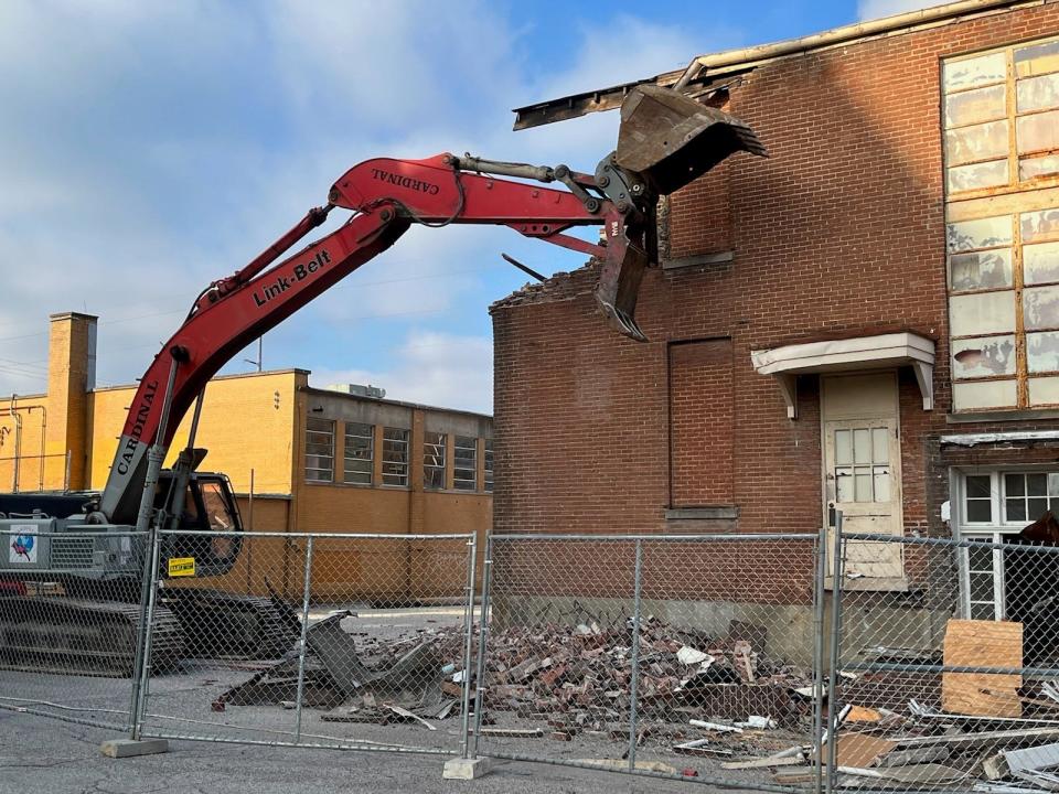 Crews work Monday morning to tear down aging buildings on the Catholic Charities of Louisville campus at 2911 S. Fourth Street. Feb. 14, 2022