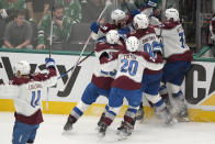 Colorado Avalanche's Andrew Cogliano (11), Nathan MacKinnon (29), Ross Colton (20), Mikko Rantanen (96), Casey Mittelstadt and Miles Wood, center rear, celebrate after Wood scored in overtime in Game 2 of an NHL hockey Stanley Cup second-round playoff series against the Dallas Stars in Dallas, Tuesday, May 7, 2024. (AP Photo/LM Otero)