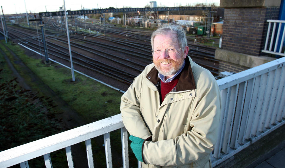 Author Bill Bryson stands alongside the railway track at Mill Road in Cambridge as he is leading a legal battle to clear litter from the railways.