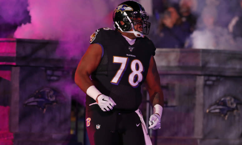 Orlando Brown Jr. walks onto the field.