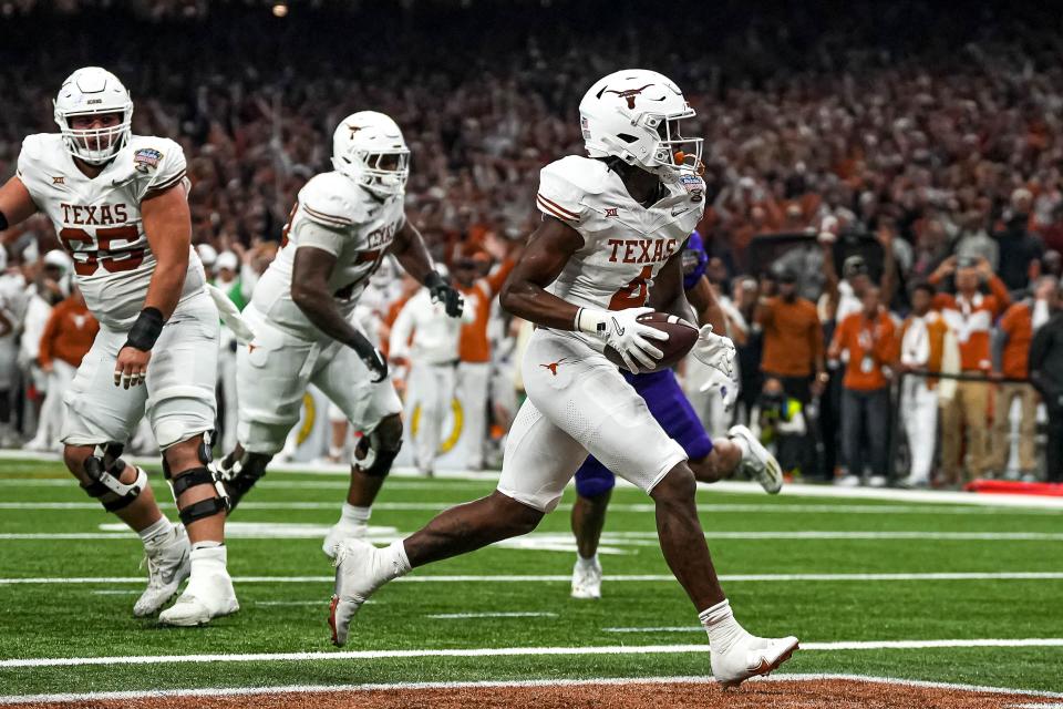 Texas Longhorns running back CJ Baxter (4) runs in for a touchdown during the Sugar Bowl College Football Playoff semifinals game against the Washington Huskies at the Caesars Superdome on Monday, Jan. 1, 2024 in New Orleans, Louisiana. Credit: Aaron E. Martinez/American-Statesman-USA TODAY NETWORK