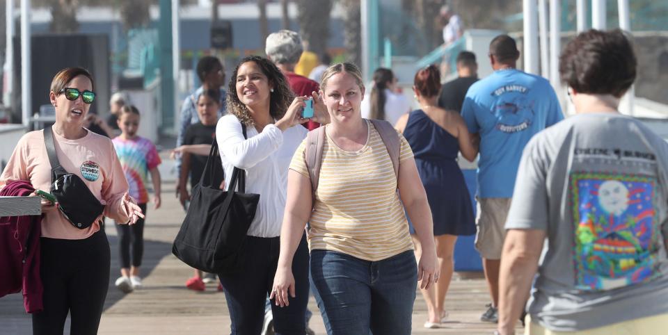 Tourists enjoy a sunny afternoon the Daytona Beach Boardwalk as the holidays approach at the World's Most Famous Beach. After two record-setting years, tourist development tax collections were down in 2023, but optimism remains high for 2024.