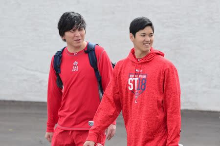 Feb 13, 2018; Tempe, AZ, USA; Los Angeles Angels pitcher Shohei Ohtani (right) looks on during a workout at Tempe Diablo Stadium. Mandatory Credit: Matt Kartozian-USA TODAY Sports