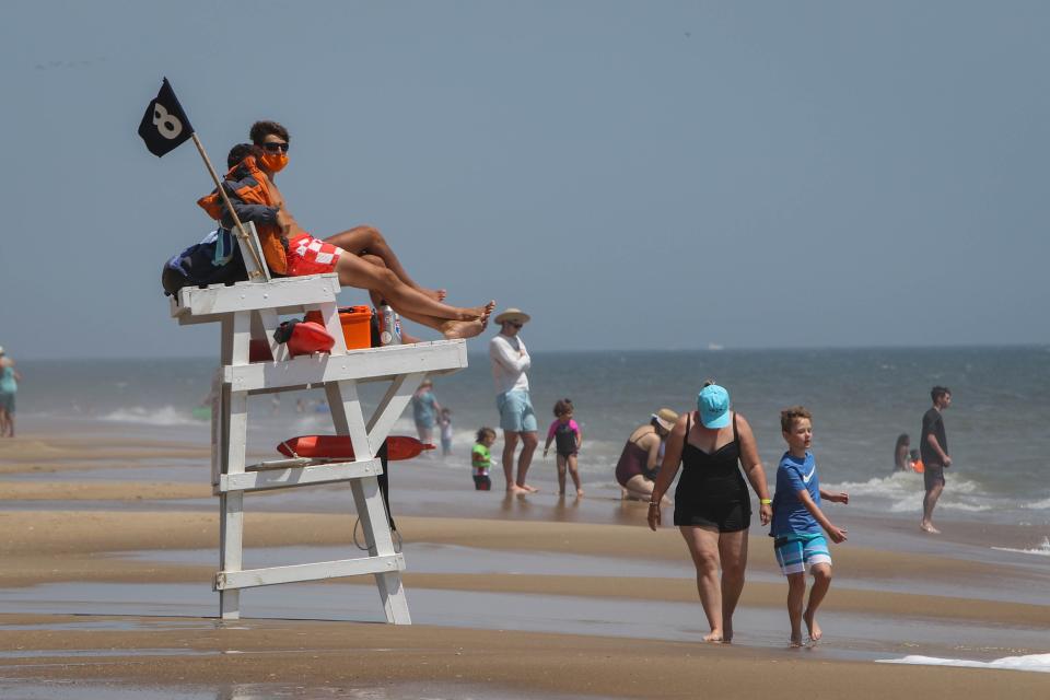 Lifeguards watch over a crowded Bethany Beach on a warm breezy Wednesday, June 10. They've been trained to work in teams for rescues, wearing masks and gloves when possible due to coronavirus.