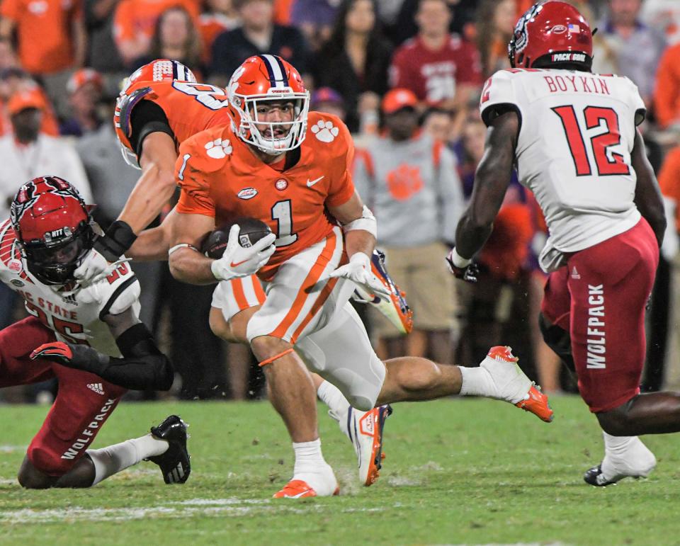 Clemson running back Will Shipley (1) runs near NC State defensive back Devan Boykin (12) during the first quarter at Memorial Stadium in Clemson, South Carolina Saturday, October 1, 2022.   