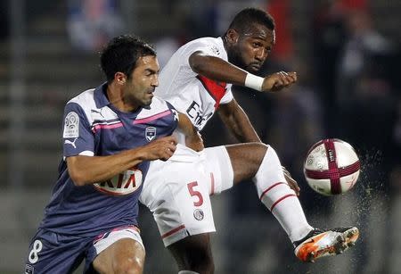 Paris St Germain's Siaka Tiene (R) fights for the ball with Fahid Ben Khalfallah (L) of Girondins Bordeaux, during their French Ligue 1 soccer match at the Chaban Delmas Stadium in Bordeaux November 6, 2011. REUTERS/Regis Duvignau