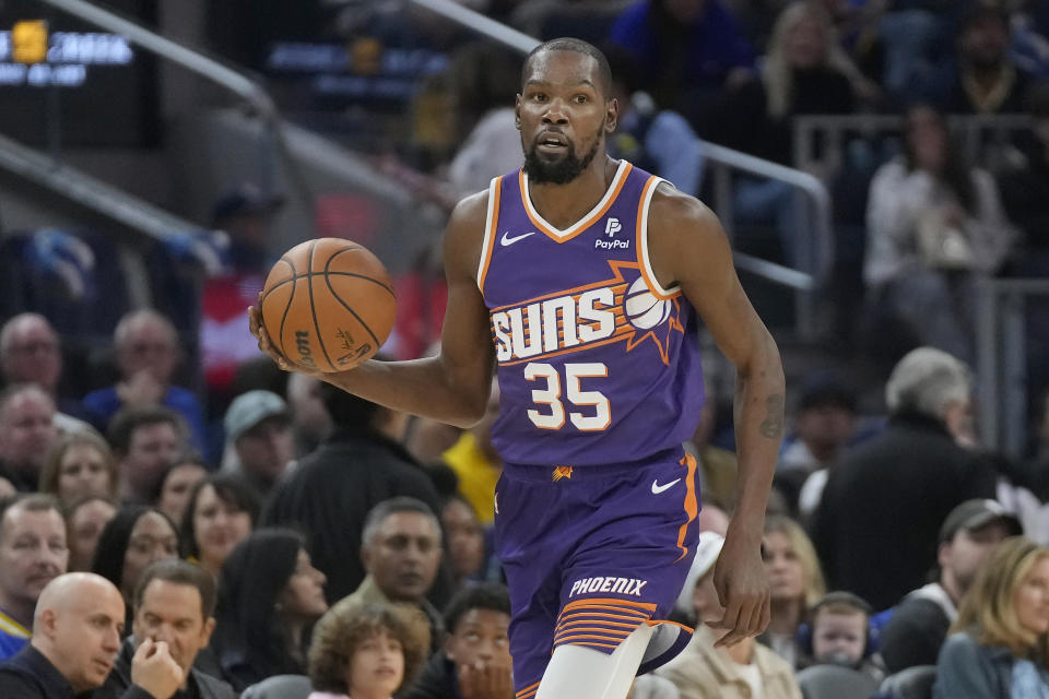 Phoenix Suns forward Kevin Durant brings the ball up against the Golden State Warriors during the first half of an NBA basketball game in San Francisco, Tuesday, Oct. 24, 2023. (AP Photo/Jeff Chiu)