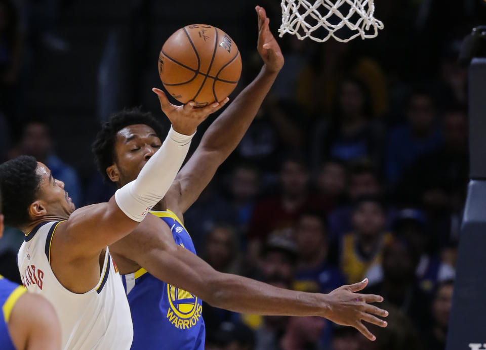 Denver Nuggets guard Gary Harris shoots against Golden State Warriors center Damian Jones (15) during the first quarter of an NBA basketball game, Sunday, Oct. 21, 2018, in Denver. (AP Photo/Jack Dempsey)