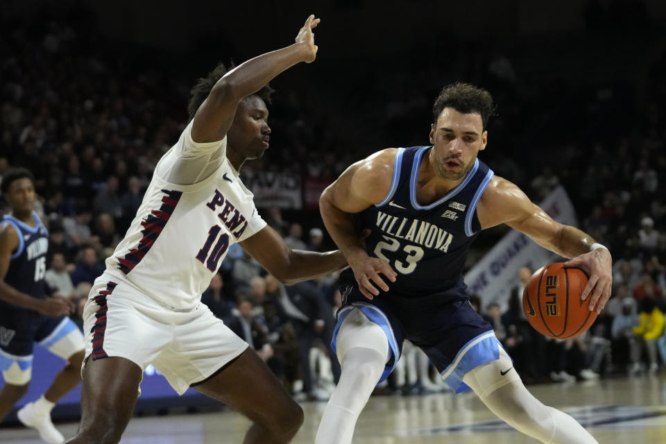 Villanova's Tyler Burton, right, tries to get past Pennsylvania's Eddie Holland III during the first half of an NCAA college basketball game, Monday, Nov. 13, 2023, in Philadelphia. (AP Photo/Matt Slocum)