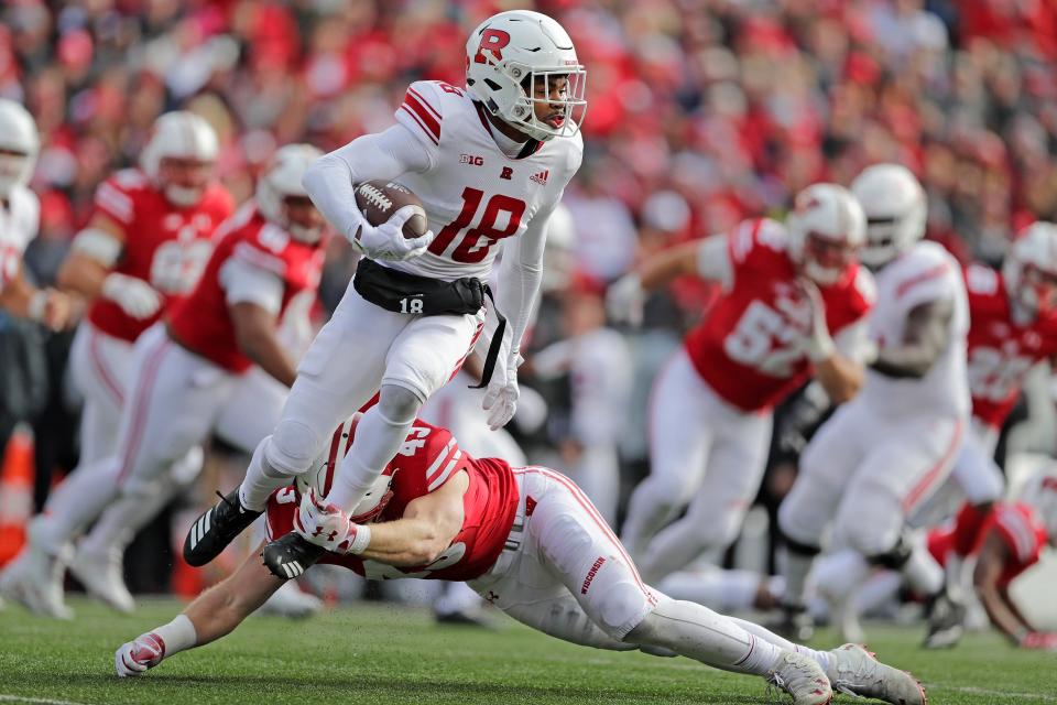 Wisconsin linebacker Ryan Connelly tackles Rutgers wide receiver Bo Melton.