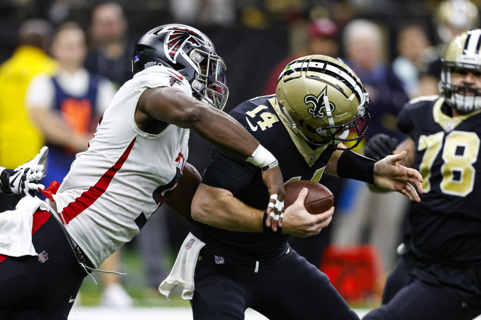 FILE - Atlanta Falcons linebacker Lorenzo Carter (9) sacks New Orleans Saints quarterback Andy Dalton (14) in the first half of an NFL football game in New Orleans, Sunday, Dec. 18, 2022. Outside linebacker Lorenzo Carter, who was second on the team with four sacks in 2022, will remain with the Atlanta Falcons on a two-year deal announced by the team on Tuesday, March 7, 2023.(AP Photo/Butch Dill, File)