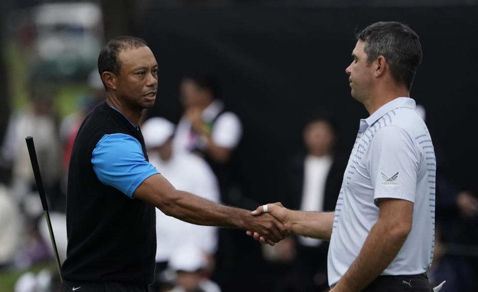 Tiger Woods of the United States, shakes hands with Gary Woodland of the United States on the18th hole after finishiing the third round of the Zozo Championship PGA Tour at the Accordia Golf Narashino country club in Inzai, east of Tokyo, Japan, Sunday, Oct. 27, 2019. (AP Photo/Lee Jin-man)