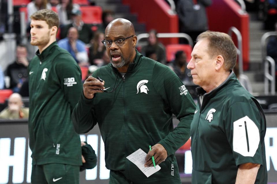 Michigan State's longtime assistant coach Mike Garland, center, left his spot on Tom Izzo's bench for a period this season while his son, Ray, recovered from heart surgery in Cleveland.